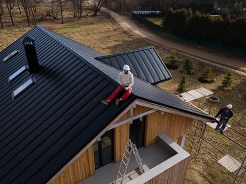 long-shot-man-with-helmet-sitting-roof