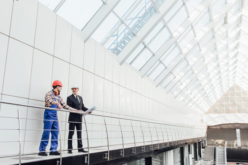 standing-industrial-engineers-blue-vests-helmets
